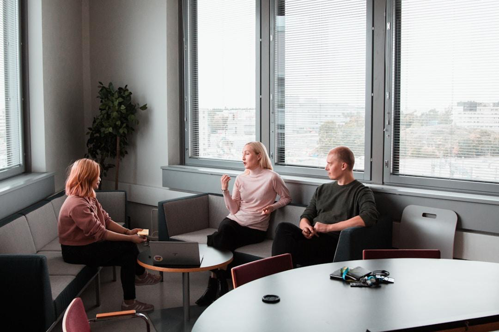 A group of professionals in an office conference room gathered around a table, evaluating the user interface and ease of integration of sales opportunity management software